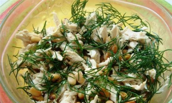 Light chicken fillet salad with dill and pine nuts