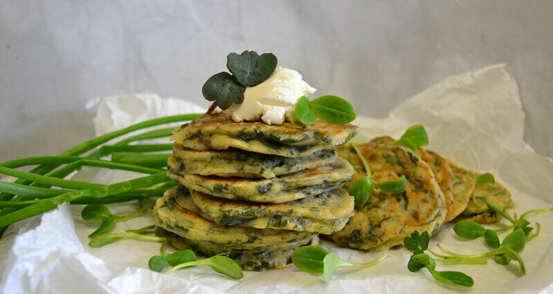 Green pancakes with vegetable tops, spinach, green onions, homemade yogurt