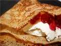 Thin milk pancakes with cream cheese and currants